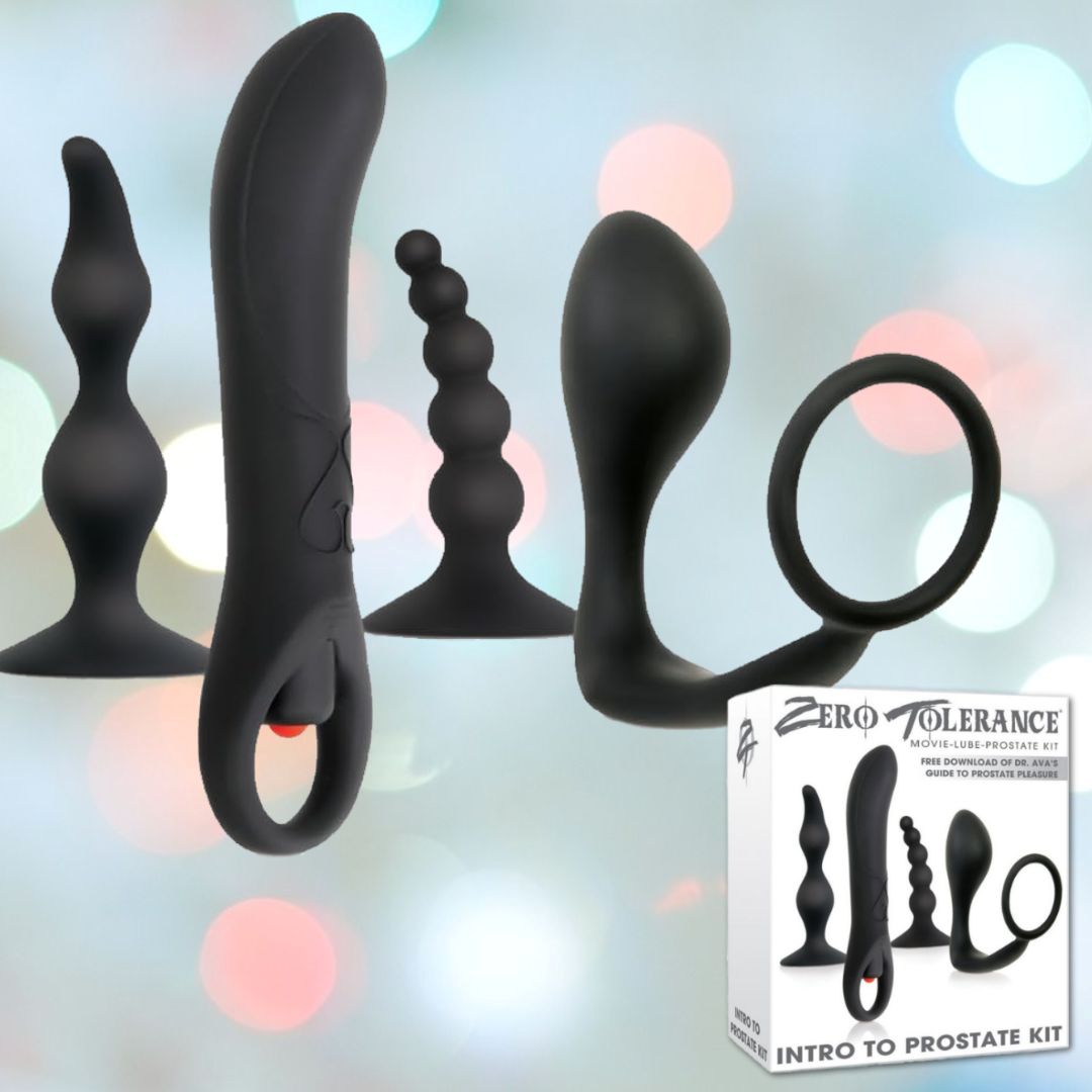 An array of five black non-vibrating prostate massagers in various shapes and sizes is displayed against a backdrop of blurred colorful lights. Beside them, a box labeled "Zero Tolerance Intro to Prostate Kit" stands, ideal for those new to prostate play.