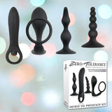 Image showing four black silicone anal toys of varying shapes and sizes, positioned above a white and grey box labeled "Zero Tolerance: Intro to Prostate Kit with Non-Vibrating Prostate Massagers." The background is softly blurred with glowing pastel lights, creating an inviting ambiance for prostate play.